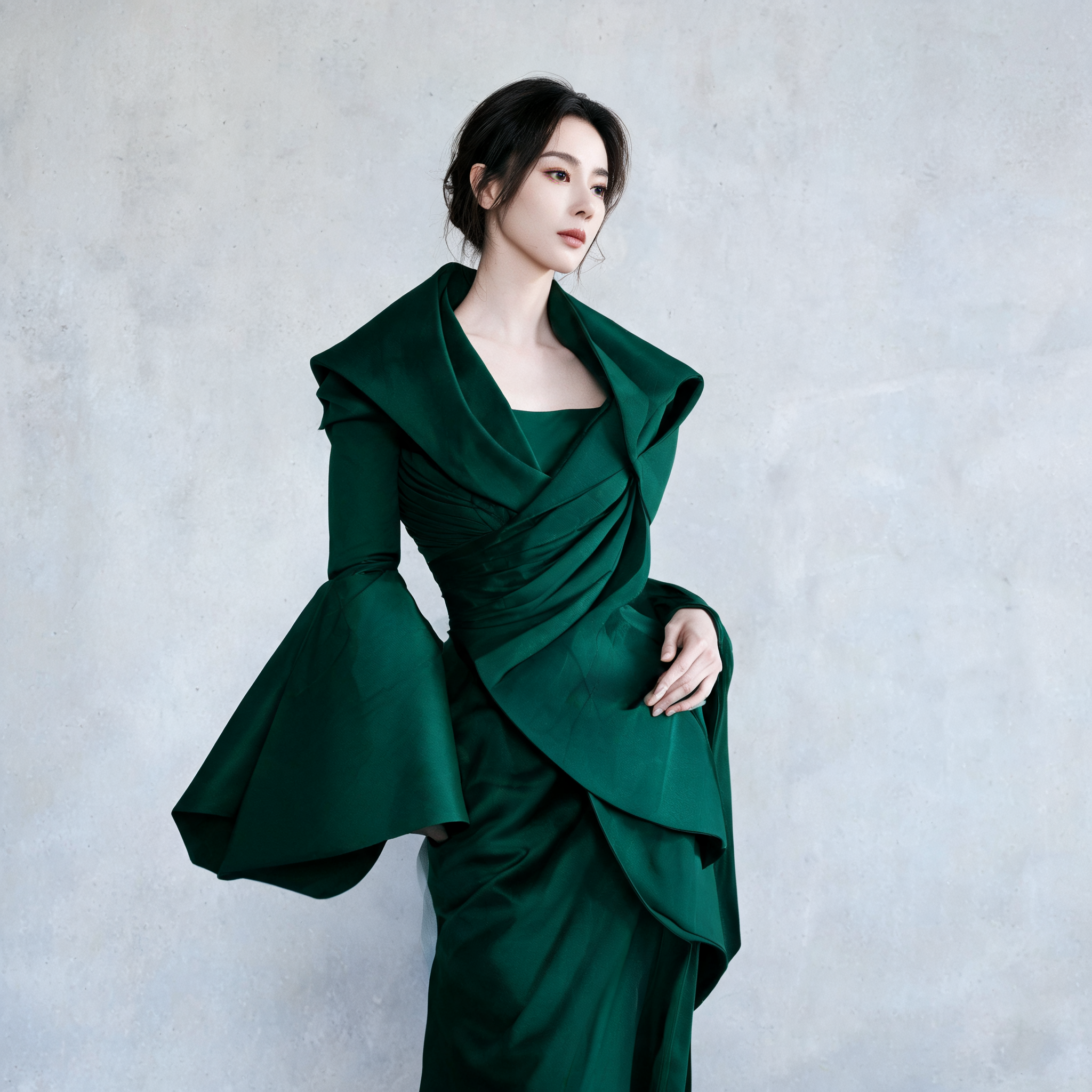 Fashion model wearing a sculptural emerald outfit
